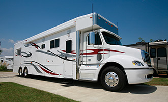 A white class a motorhome parked at an RV park